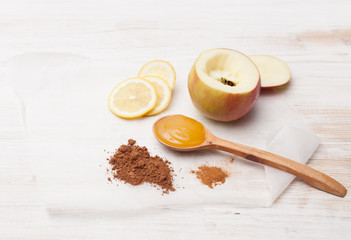 Cocoa, cinnamon, apple, lemon and honey on the table