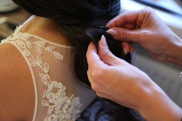 Obraz na płótnie Canvas bride with dark hair is getting dressed