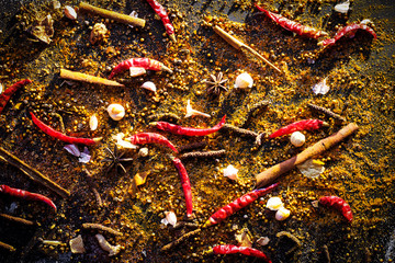 Variety Spices and herbs on black stone background, Top view with empty space background for texture. Italian food, eastern food concept.