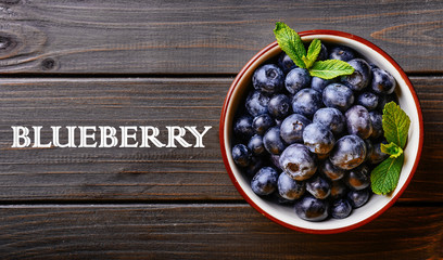 Blueberry. Freshly picked blueberries over wooden table.