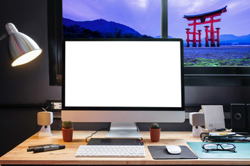 Fototapeta premium Graphic designer's workspace equipped with a pen tablet, a computer and white screen for text with Tori Gate View