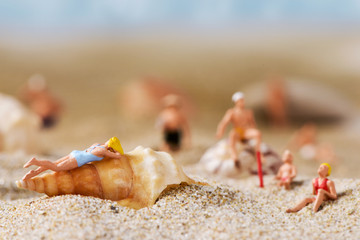 Fototapeta na wymiar miniature people in swimsuit on the beach