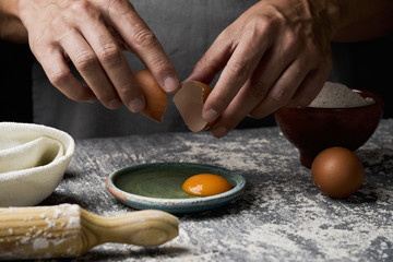young man cracking an egg