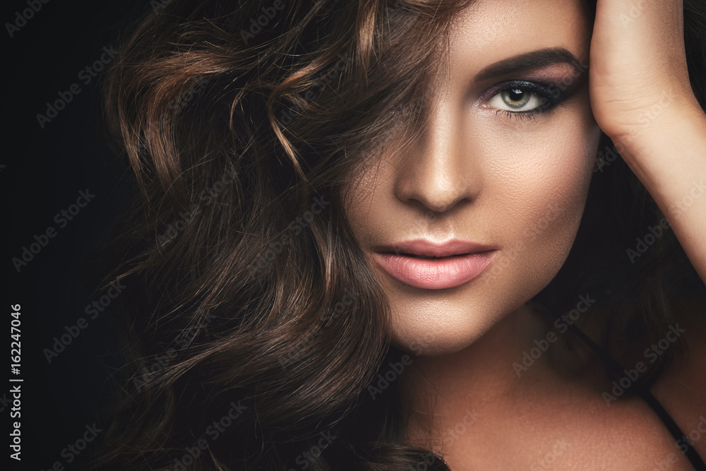 Poster woman with curly hair and beautiful make-up