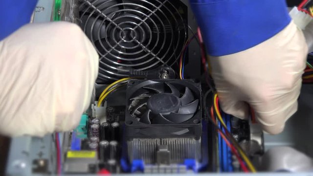Technician disconnects power cable pins from computer motherboard and remove RAM