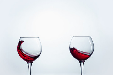 Two wine glasses against white