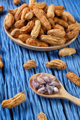 Peanuts on blue wood background