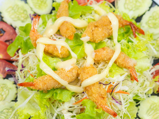 Shrimp Fried on Vegetable Salad in Black Plate.