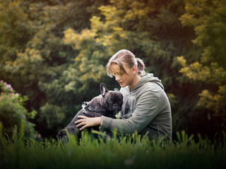 Girl hugging a dog. Nature, green grass, beautiful