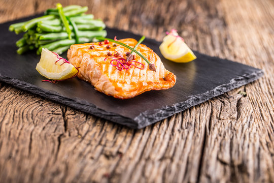 Grilled Salmon. Salmon fillet with lemon and green beans. Grilled fish.