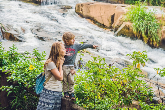 Mother and son on the background of Beautiful Camly waterfall In Da Lat city