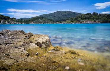 Blue water bay land rocks beach long exposure Croatia - 162250218