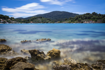 Blue water bay and rocks beach long exposure Croatia - 162250238