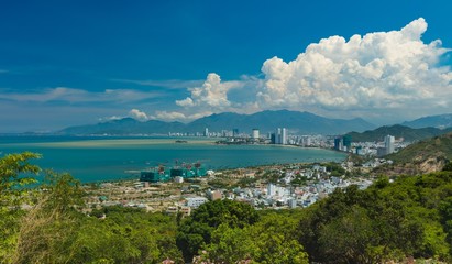 Fototapeta premium Looking out over Asian holiday resort Nha Trang Vietnam and the south China sea on a beautiful sunny day.