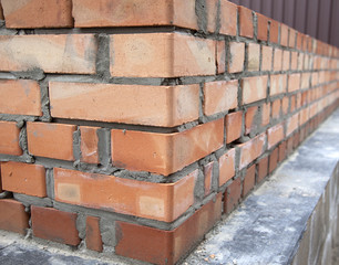 Construction of houses, masonry walls made of red bricks and cement