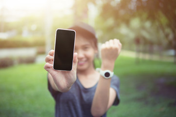 woman runner showing blank smart phone screen and gadget accessories,workout statistic information such as pulse and heart rate technology can help people who training and fitness,vintage tone