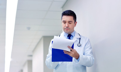 doctor with clipboard at hospital corridor