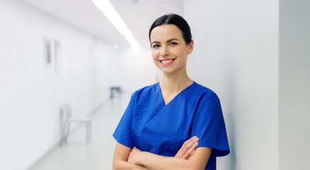 happy doctor or nurse at hospital corridor - Powered by Adobe