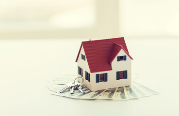 close up of home model, money and house keys