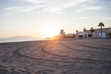 sunset on a lonely beach in spain with guard tower