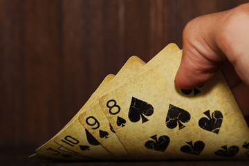 Vintage poker cards holded in a man hand