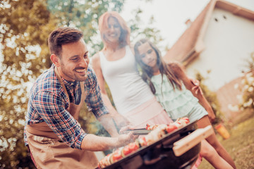 Happy family having a barbecue in summer