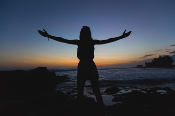 Fototapeta premium Girl enjoying the ocean with arms wide open.