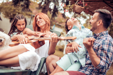 Family having fun,playing the guitar