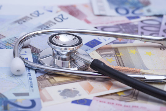 Euro banknotes and stethoscope close up