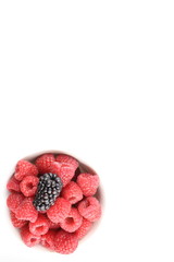 fresh blackberry and red raspberry fruits in a small white bowl