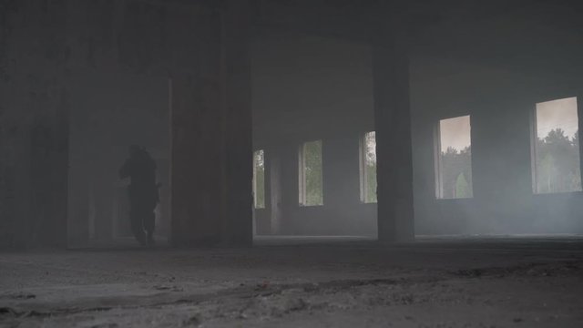 Soldiers are in a building full of smoke