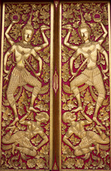 Thai fine art on the wooden temple door at Chiang Mai province 