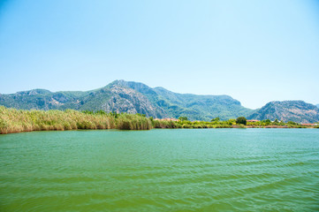 Obraz premium The Dalyan River with tourist boat in the straits of the river