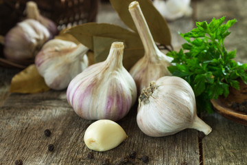 peeled chive of garlic on a blurry background of garlic heads