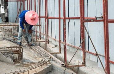 Worker use electric concrete breaker at construction site.