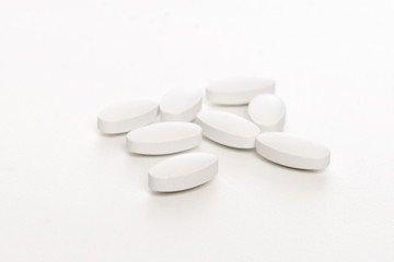 white pills on white background
