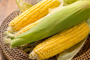 Fresh corn on rustic wooden table, closeup