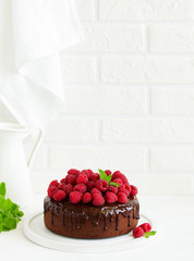 Delicious chocolate cake with chocolate icing and raspberries.