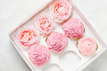 Pink cupcakes with roses in box. Festive and bright. Wedding Celebration concept.