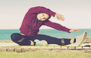 girl exercising on exercise mat outdoor