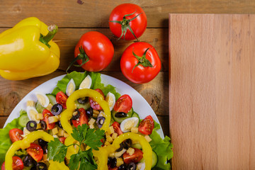 Vegetable salad with tomatoes, olives, yellow pepper, Pekinese cabbage