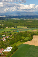 Fototapeta na wymiar Landscape mountains, village houses. A view of the earth from the sky. Shooting from the Copter Mountain Jura. France