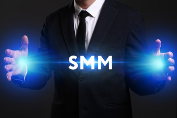 Business, Technology, Internet and network concept. Young businessman working on a virtual screen of the future and sees the inscription: SMM