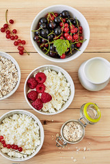 Healthy breakfast - yogurt with muesli, cottage cheese and berries.Health and diet concept.Top view