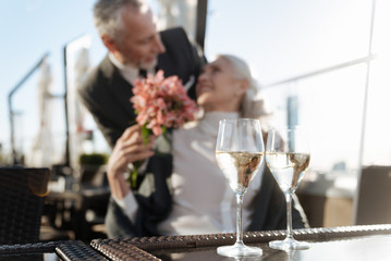Focused photo of glasses with champagne that standing on the table