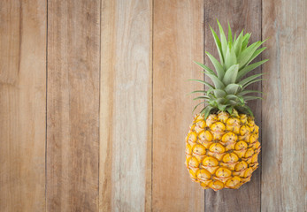 Pineapple on the old wooden table.