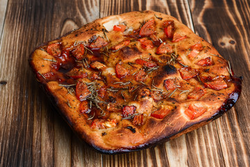 Focaccia with tomatoes on the table