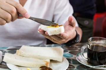 Series of person applying butter and kaya to steamed bread
