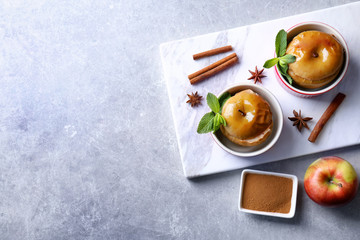 Composition with tasty baked apples and cinnamon on light table