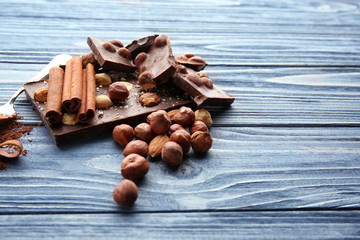 Dark chocolate pieces with cinnamon on wooden table